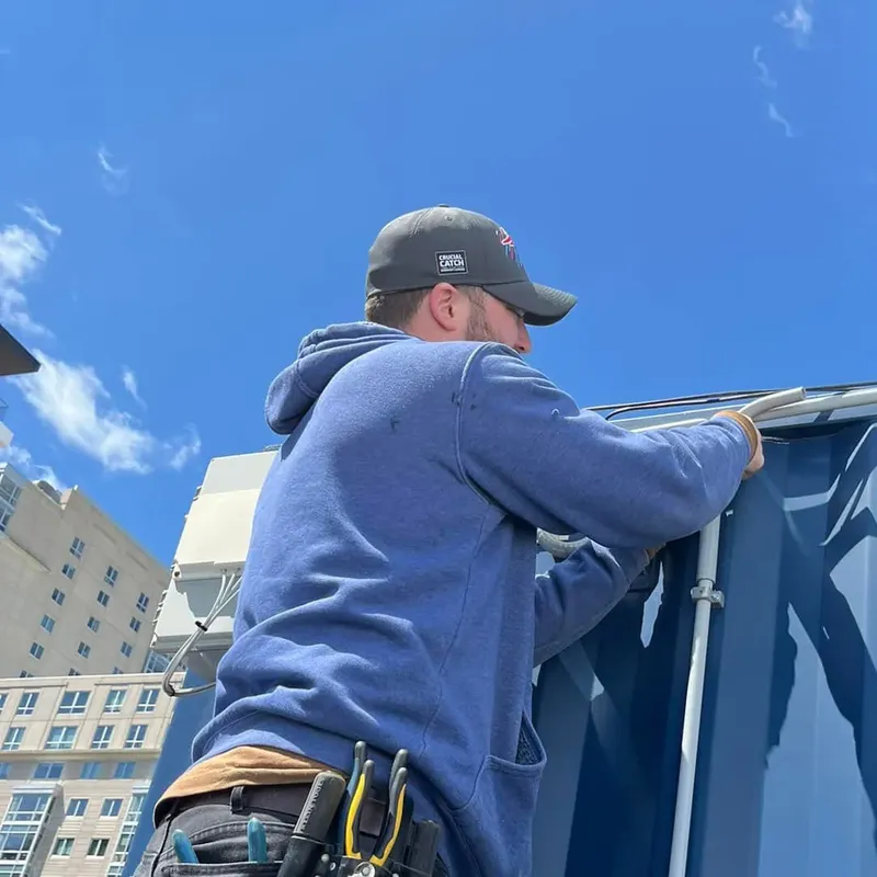 Electrician working on an exterior wall in Boston
